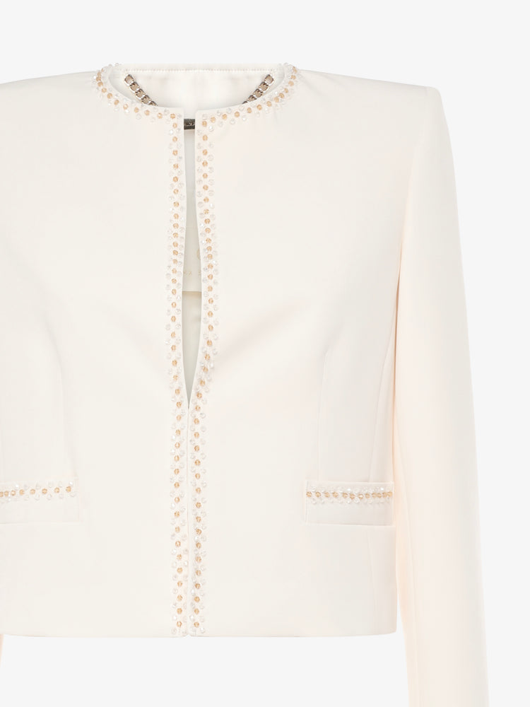 Short jacket in technical edge fabric with jewel applications