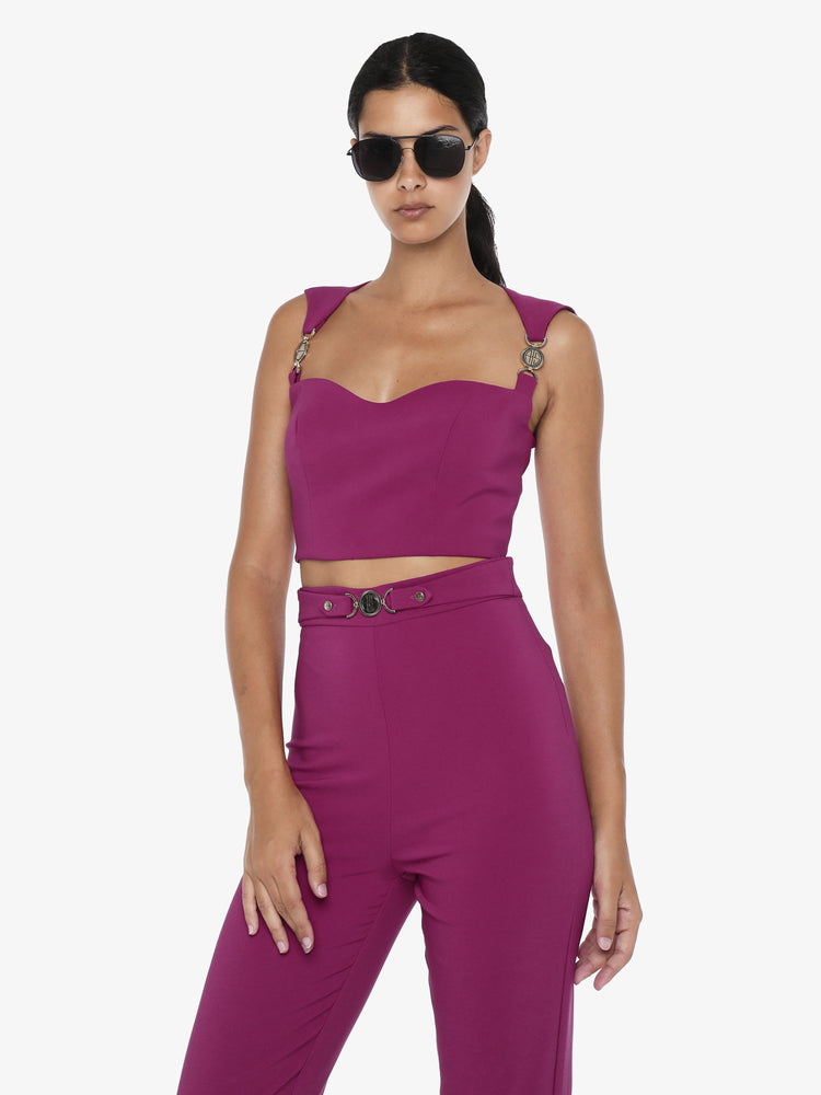 Short top in technical fabric with metal accessories on the shoulder straps