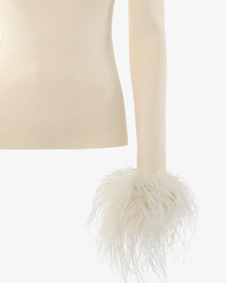 Maglia a collo alto con bottoni metallici e polsi piume