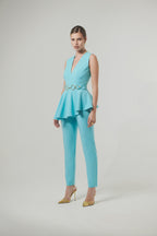 Elegant jumpsuit in technical fabric with ruffles and metallic decoration at the waist